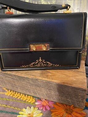 Michelangelo Black Leather Handbag with Gold Accents, looks new inside.